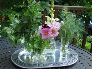 Parsley, Cilantro, and Dill surround some fresh cut flowers.