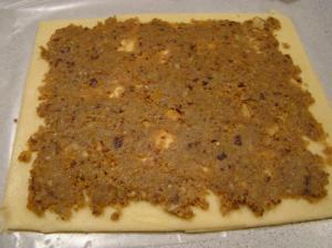 Dough spread with filling, ready to roll